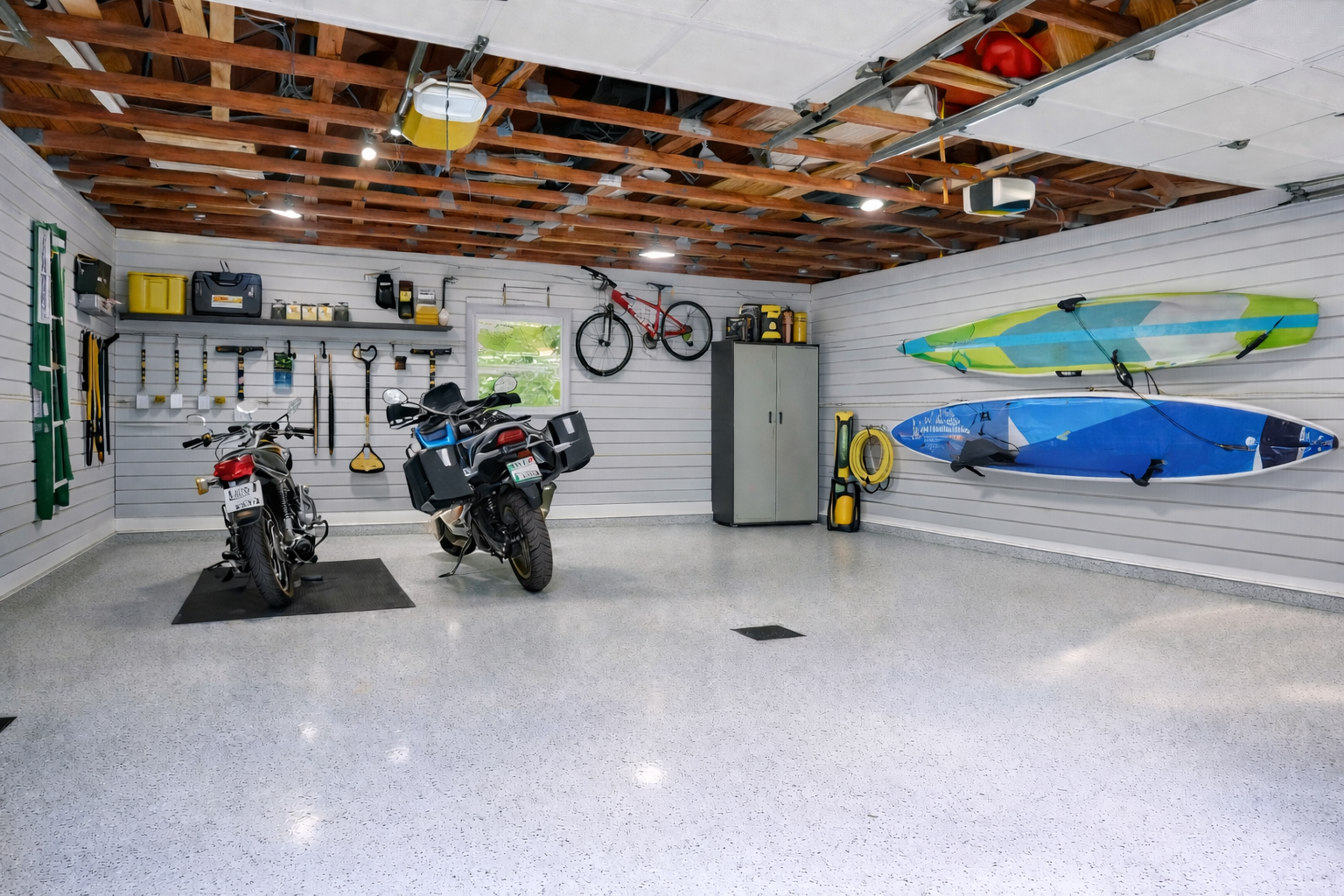 After garage transformation with organized tools on gray slatwall system, clean and functional garage design