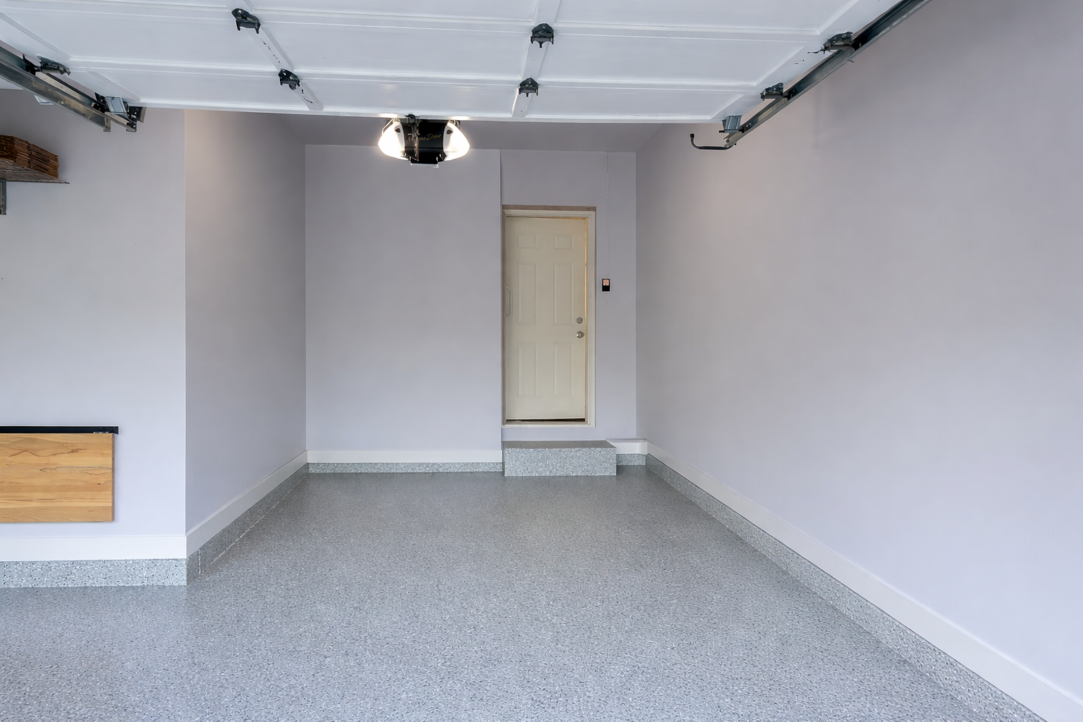 Before garage transformation, cluttered garage with tools and storage, no slatwall system